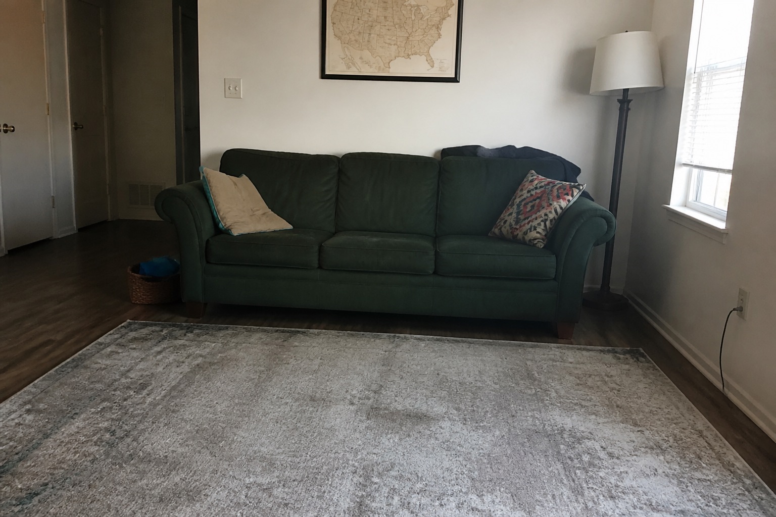 Room with green three-seat sofa, before