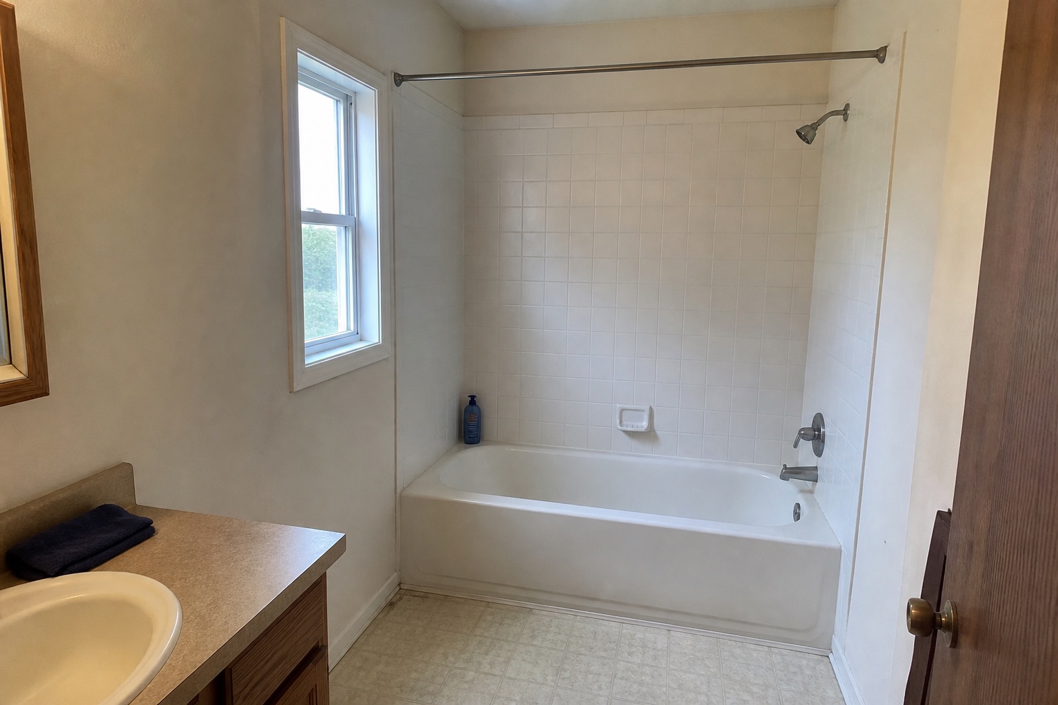 Room with a white tub and rod, before